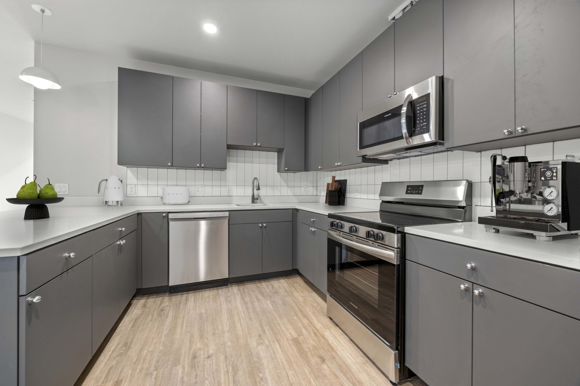 High-end fitted kitchen appliances and premium countertops in a luxury apartment at The Cooper in Lakewood, CO